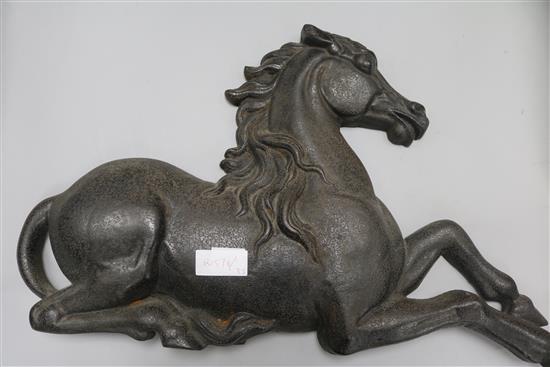 A cast iron horse doorstop